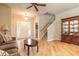 Inviting living room featuring light wood floors, a ceiling fan, and an elegant wooden hutch at 6950 Vintage Ln, Port Orange, FL 32128