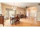Sunlit living area with hardwood floors, chandelier, and stylish furniture, offering a comfortable space at 6950 Vintage Ln, Port Orange, FL 32128