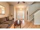 Welcoming living room featuring tile entry, a ceiling fan, staircase, and natural light at 6950 Vintage Ln, Port Orange, FL 32128