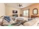Comfortable living room featuring neutral carpet, a ceiling fan, and a decorative entertainment center at 6950 Vintage Ln, Port Orange, FL 32128