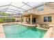 Backyard pool and spa with screened enclosure, covered patio, and outdoor seating area at 6950 Vintage Ln, Port Orange, FL 32128