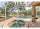 Screened pool and a spa with a water feature and a view of the pond and landscaping at 6950 Vintage Ln, Port Orange, FL 32128