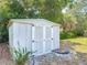 Close-up view of a backyard storage shed with double doors, providing convenient storage space at 836 6Th St, Port Orange, FL 32129