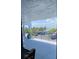 Balcony view highlighting the waterfront with parking and palm trees, offering a glimpse of coastal living and relaxation at 845 Ladyfish Ave # B204, New Smyrna Beach, FL 32169
