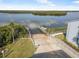 Aerial shot showcasing a private boat ramp, lush landscaping, and direct waterfront access to calm waters for boating at 845 Ladyfish Ave # B204, New Smyrna Beach, FL 32169