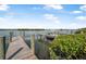 Charming boat dock with a vessel moored, surrounded by tranquil waters and green foliage, ideal for waterfront relaxation at 845 Ladyfish Ave # B204, New Smyrna Beach, FL 32169