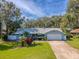 Attractive single-story house with beautiful landscaping and a long driveway at 872 Reservation Ct, Port Orange, FL 32129