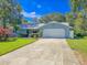 Charming single-story home boasts a lush green lawn and a convenient two-car garage at 872 Reservation Ct, Port Orange, FL 32129