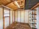Interior of a backyard shed featuring wooden framing, lighting, and shelving for storage solutions at 872 Reservation Ct, Port Orange, FL 32129