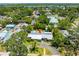 Aerial view showcases the neighborhood, green trees and highlights the metal roof at 913 Palmetto St, New Smyrna Beach, FL 32168