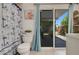 This bathroom features a combination shower and tub with an ocean-themed curtain and a sliding glass door at 913 Palmetto St, New Smyrna Beach, FL 32168