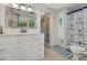 This bathroom has a vanity, a mirror, and a combination shower and tub with a mermaid theme at 913 Palmetto St, New Smyrna Beach, FL 32168