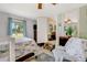 This bedroom includes tile floors, a ceiling fan, and an open door leading to another room at 913 Palmetto St, New Smyrna Beach, FL 32168