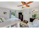 This bedroom features tile floors, a dresser with a television, and a window at 913 Palmetto St, New Smyrna Beach, FL 32168