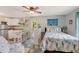 This is a bright bedroom with a partial kitchen, ceiling fan, and ocean-themed decor at 913 Palmetto St, New Smyrna Beach, FL 32168