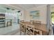 Charming dining area with a view into the kitchen, a large wooden table, and seating for four at 913 Palmetto St, New Smyrna Beach, FL 32168