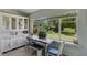 Cozy dining area with a large window, a built-in cabinet, and seating for four at 913 Palmetto St, New Smyrna Beach, FL 32168