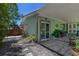 Exterior view of this home with a wooden patio, a fenced backyard, and lush landscaping at 913 Palmetto St, New Smyrna Beach, FL 32168