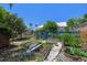 Backyard garden with raised beds and a blue fence at 913 Palmetto St, New Smyrna Beach, FL 32168