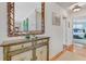 Tastefully decorated hallway with wood floors, a decorative mirror, and a view of the bedroom at 913 Palmetto St, New Smyrna Beach, FL 32168