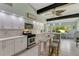 Bright kitchen featuring white cabinetry, stainless steel appliances, and a cozy breakfast nook at 913 Palmetto St, New Smyrna Beach, FL 32168