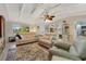 Bright and airy living room featuring two sofas, a ceiling fan, and access to the kitchen at 913 Palmetto St, New Smyrna Beach, FL 32168