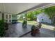 This covered patio features tile flooring, a seating area, and a view of the backyard at 913 Palmetto St, New Smyrna Beach, FL 32168