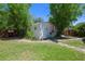 Backyard shed offers extra storage space, surrounded by mature bamboo trees at 913 Palmetto St, New Smyrna Beach, FL 32168