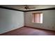 Spacious bedroom with neutral walls, a ceiling fan and natural light from the window at 1077 Willow Wood Dr, Port Orange, FL 32129