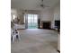 Spacious living room featuring plush carpeting, a fireplace, and sliding glass doors to the outdoor patio at 1077 Willow Wood Dr, Port Orange, FL 32129