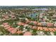 Beautiful aerial view of a residential community with lake, tennis courts, and lush landscaping at 11222 Rapallo Ln, Windermere, FL 34786