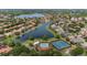 Stunning aerial view of a community with lake, tennis courts, pool, and lush landscaping at 11222 Rapallo Ln, Windermere, FL 34786
