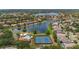 Stunning aerial view of a community with lake, tennis courts, pool, and lush landscaping at 11222 Rapallo Ln, Windermere, FL 34786