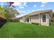 Well-maintained backyard with lush green lawn and mature landscaping, providing privacy at 11222 Rapallo Ln, Windermere, FL 34786