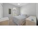 Cozy bedroom with a large window, ceiling fan, and two dressers flanking the bed at 11222 Rapallo Ln, Windermere, FL 34786
