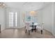 Cozy dining room with a glass-top table, four chairs, and a modern chandelier at 11222 Rapallo Ln, Windermere, FL 34786