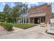 Charming building with brick detail, brewery, a grassy lawn, and covered front porch with rocking chairs at 11222 Rapallo Ln, Windermere, FL 34786