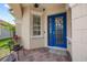 Inviting front entry with a blue door, brick pavers, and decorative window at 11222 Rapallo Ln, Windermere, FL 34786