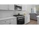 Well-equipped kitchen with stainless steel appliances, white countertops and a tiled backsplash at 11222 Rapallo Ln, Windermere, FL 34786