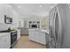 Bright kitchen featuring white cabinetry, stainless steel appliances and an island with a sink at 11222 Rapallo Ln, Windermere, FL 34786