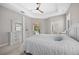 Bright main bedroom featuring a trey ceiling, ceiling fan, and ensuite bathroom at 11222 Rapallo Ln, Windermere, FL 34786