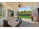 Inviting covered patio with comfortable seating, ceiling fan, and view of the fenced backyard at 11222 Rapallo Ln, Windermere, FL 34786