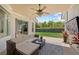 Inviting covered patio with comfortable seating, ceiling fan, and view of the fenced backyard at 11222 Rapallo Ln, Windermere, FL 34786