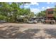 Vibrant street with diverse shops, a white Tesla, a vintage Bronco, and mature trees in a lively district at 11222 Rapallo Ln, Windermere, FL 34786