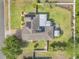 Aerial view of the house showing the roof with solar panels, back yard, and surrounding landscaping at 115 Los Arbor Dr, Deland, FL 32724