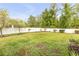 Large, well-maintained backyard with a white fence and lush landscaping, perfect for outdoor activities and relaxation at 115 Los Arbor Dr, Deland, FL 32724