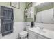 Well-lit bathroom featuring a white sink, toilet, decor, and wainscoting at 115 Los Arbor Dr, Deland, FL 32724