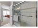 Bathroom boasting a tiled shower, grab bar, and glass door at 115 Los Arbor Dr, Deland, FL 32724