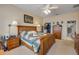 A well-lit bedroom featuring a wooden bed frame, matching dressers, and a ceiling fan at 115 Los Arbor Dr, Deland, FL 32724