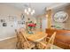 Cozy dining room featuring a wooden table, chairs, chandelier, and decor at 115 Los Arbor Dr, Deland, FL 32724